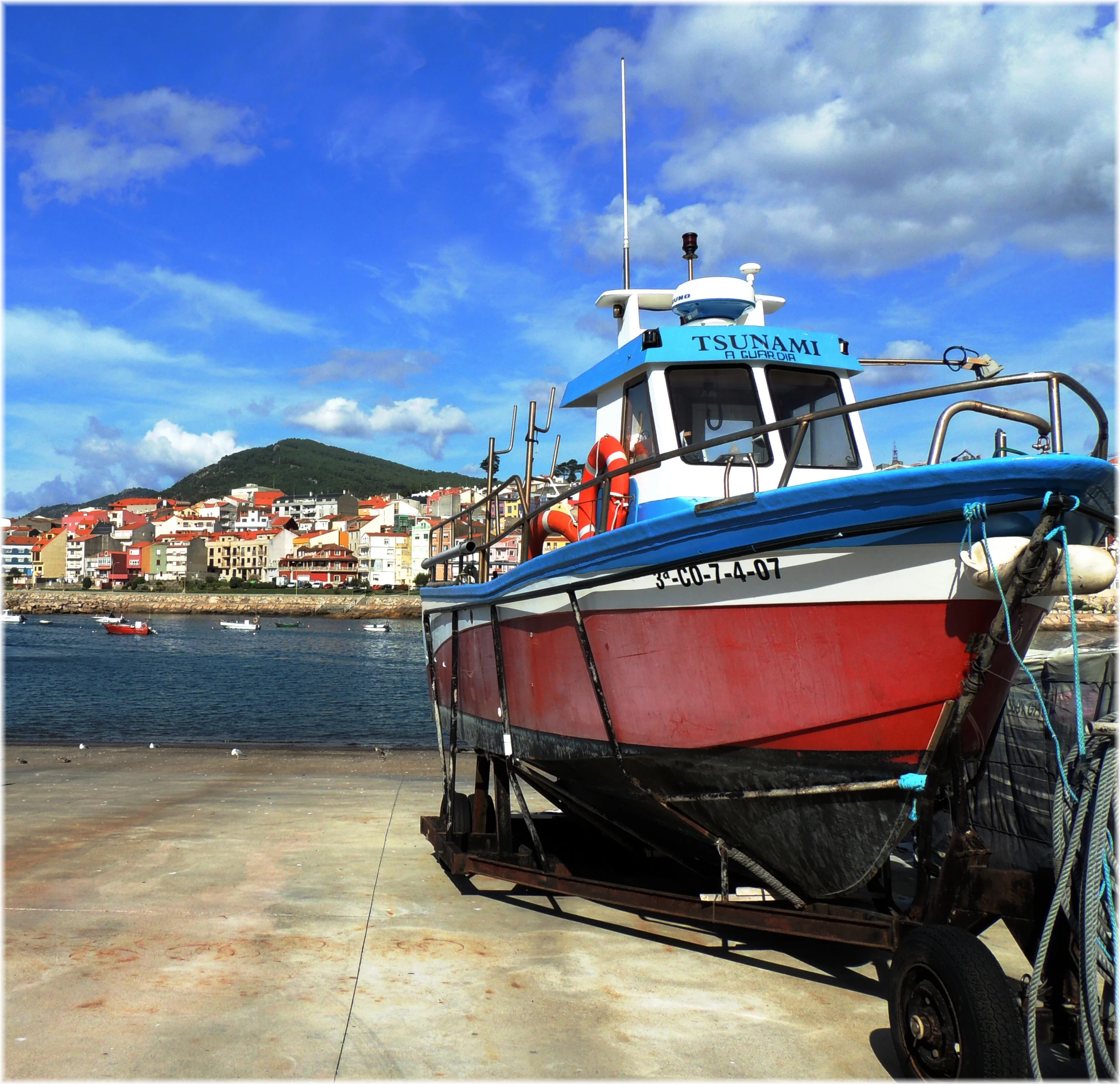 a boat docked on top of the sand near the ocean