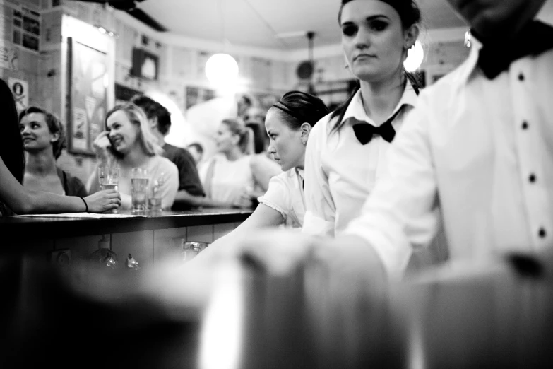 people sitting at a bar with a bow tie on