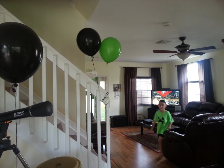 a child with some balloons in a living room