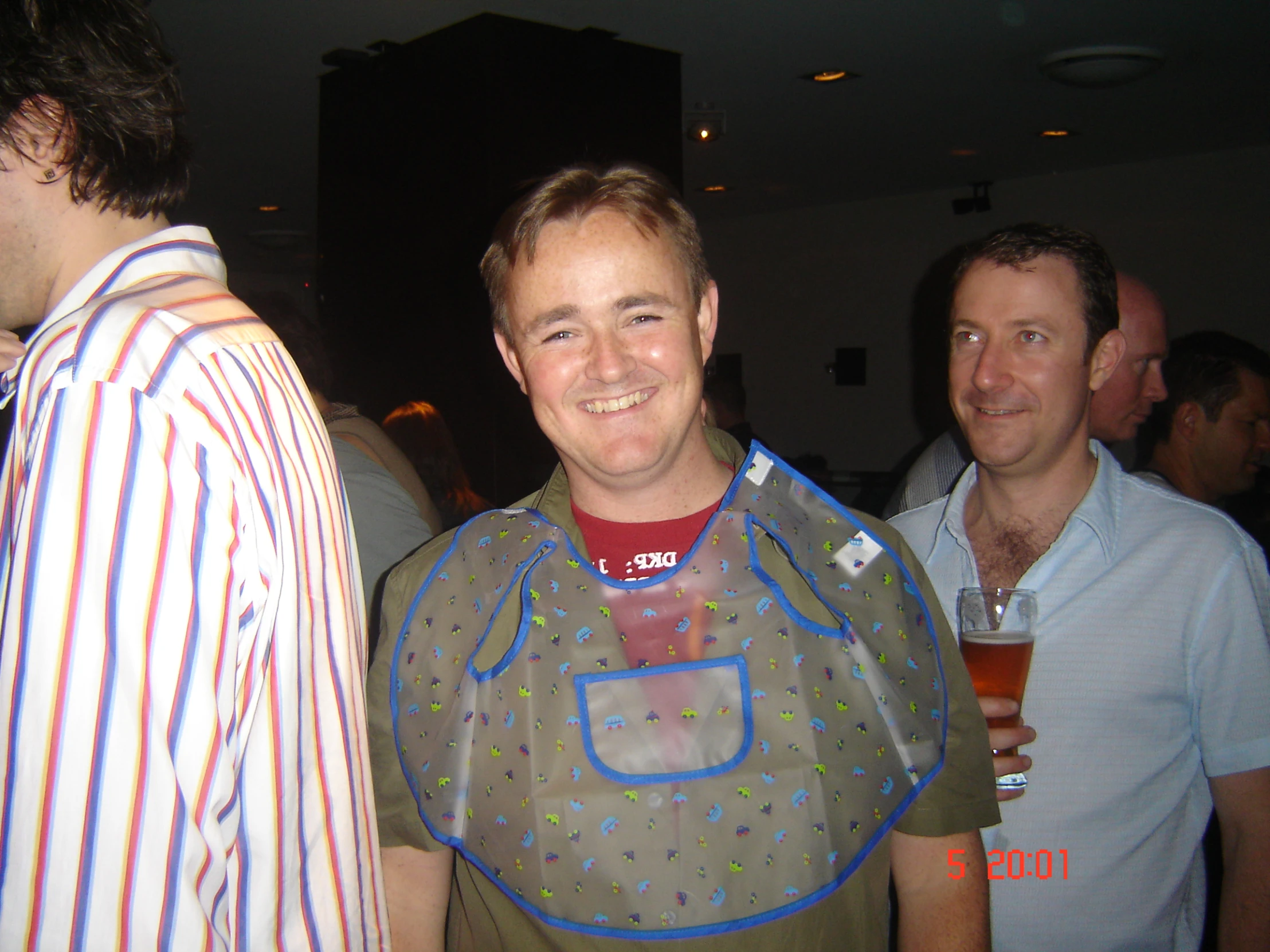 three men standing near each other wearing bibs