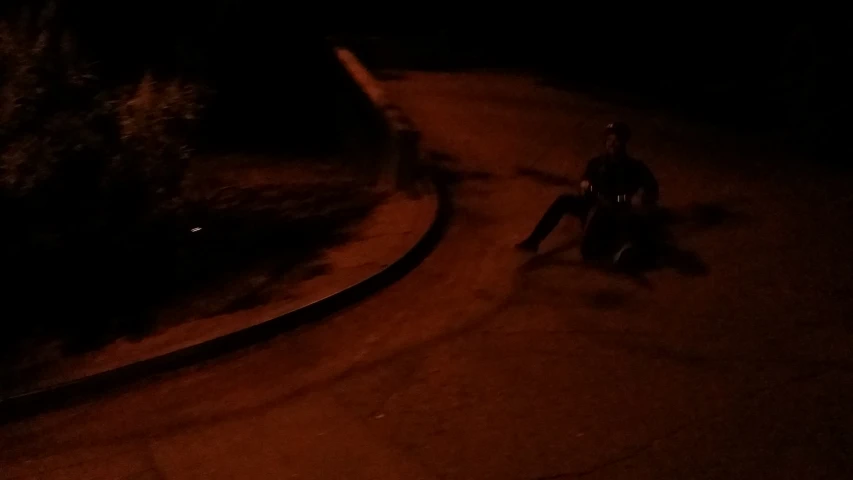 a person that is on a motorcycle in the dark