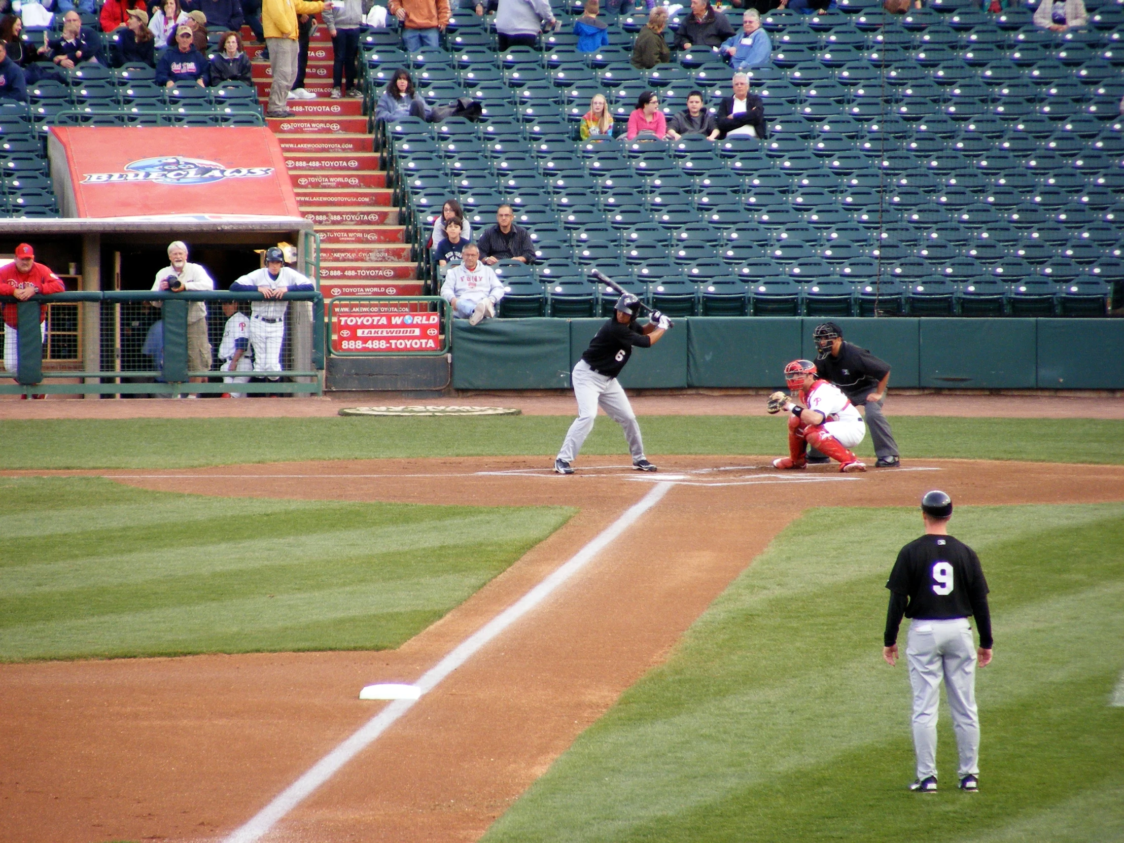 baseball players are preparing to swing at the ball