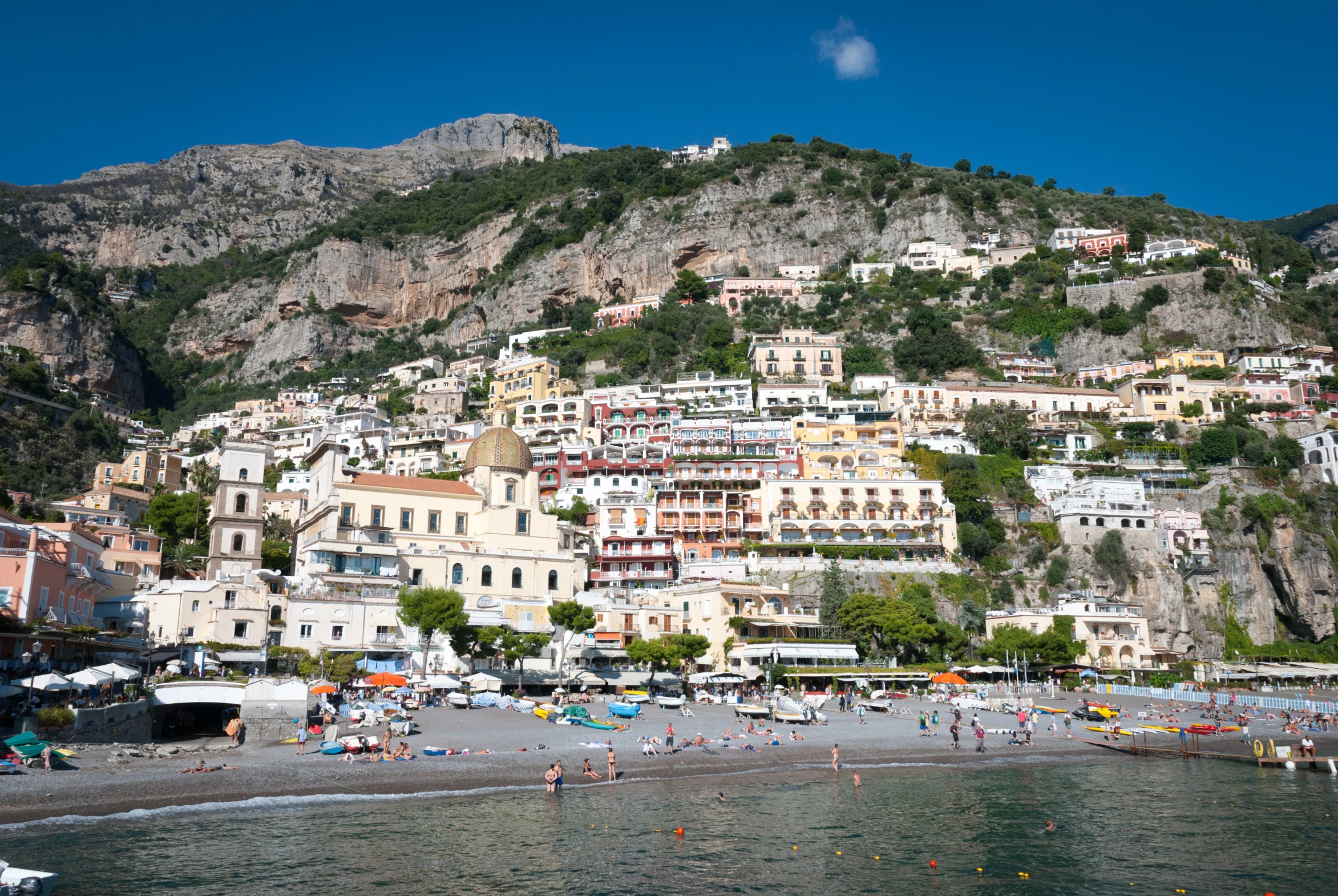 the beach and buildings is overlooking the water