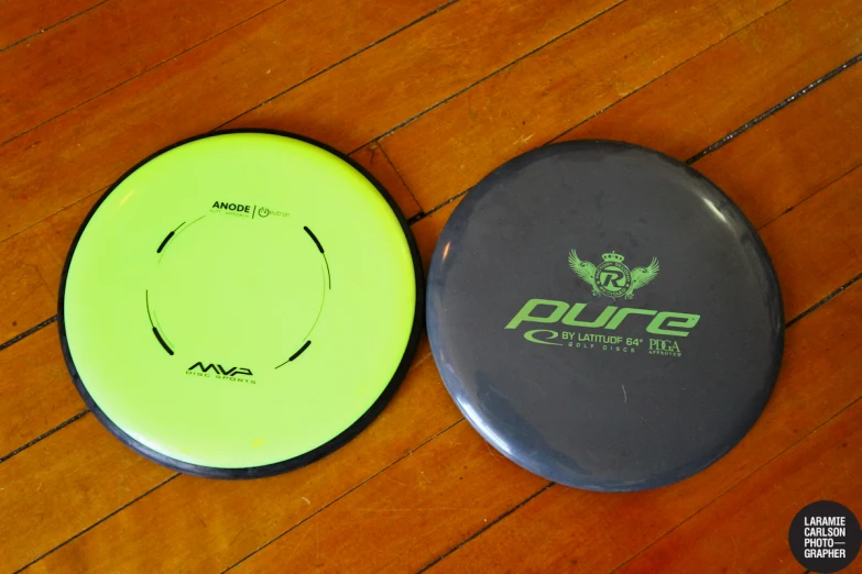 two frisbees laying on the floor in a room