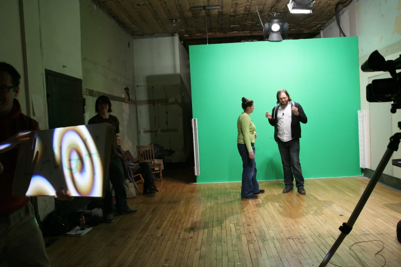some people standing in front of a green screen