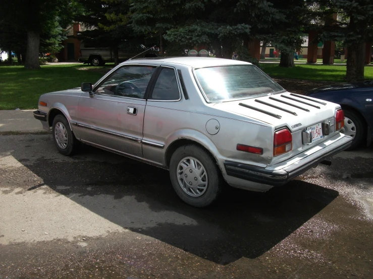 a white car parked in a driveway near a house