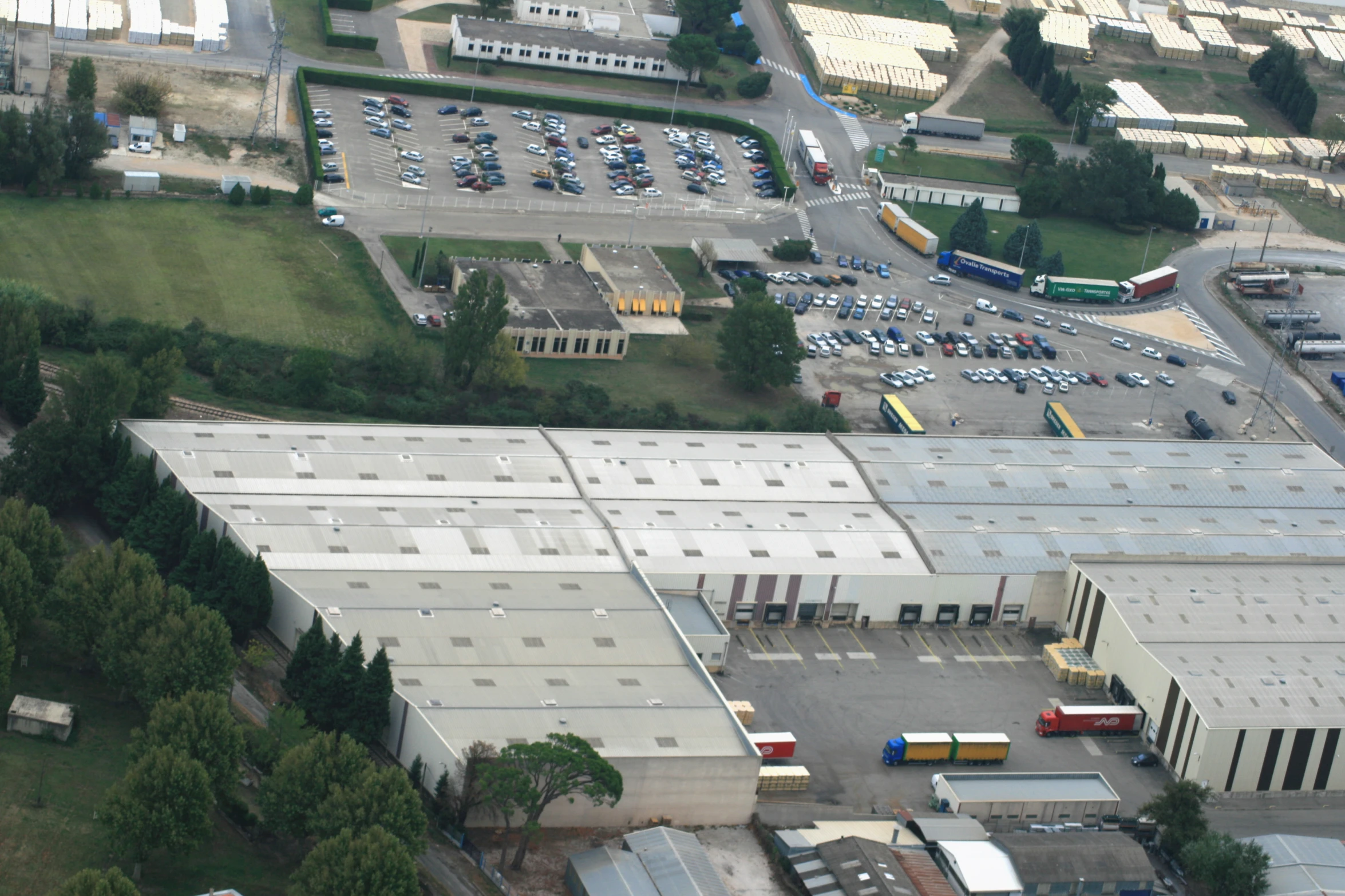 an aerial view of a factory building in a small city