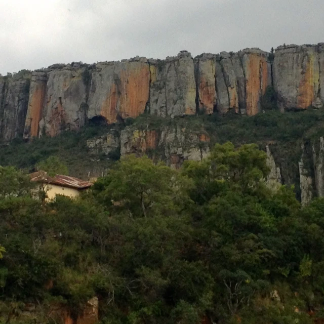 some very large mountain tops with trees by them