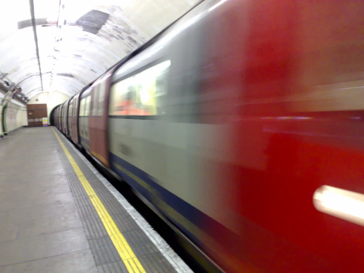 train passing under a light in an underground tunnel