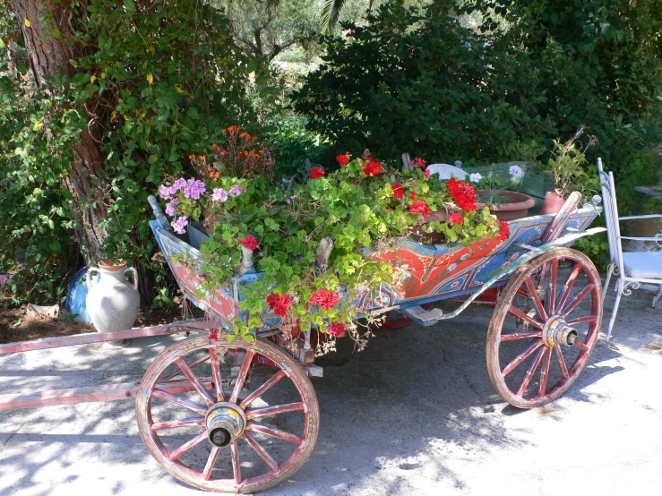 a flower wagon with a bunch of flowers sitting in it