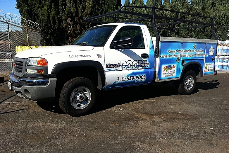 a white pick up truck with a large flat bed parked next to other trucks