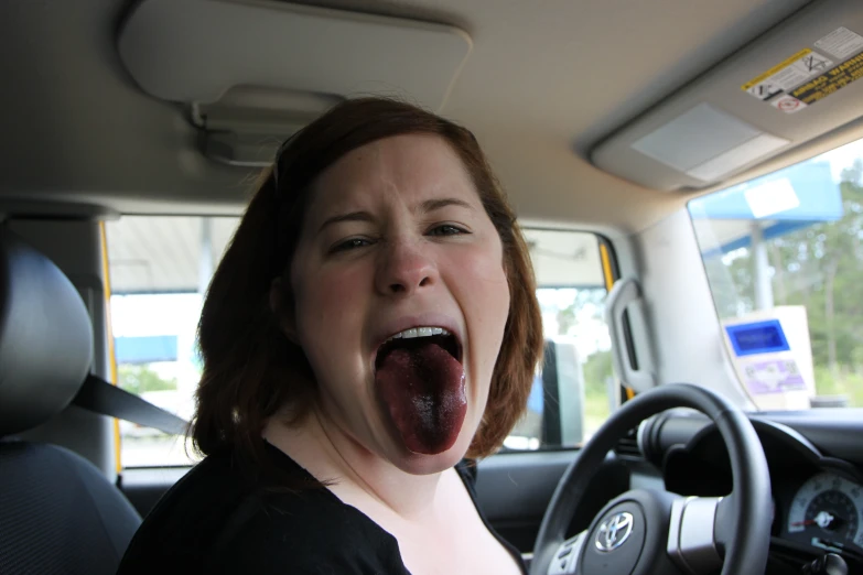 a woman with red hair holds her mouth open to her side