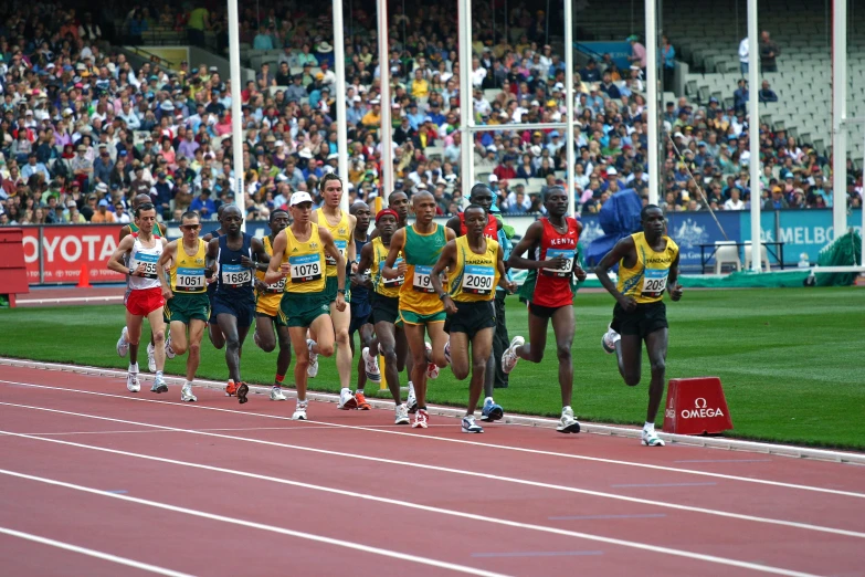 the four athletes racing down a track as people look on