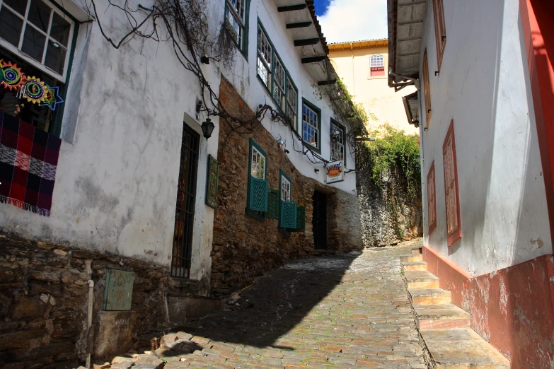 an alley way in an old village with many windows