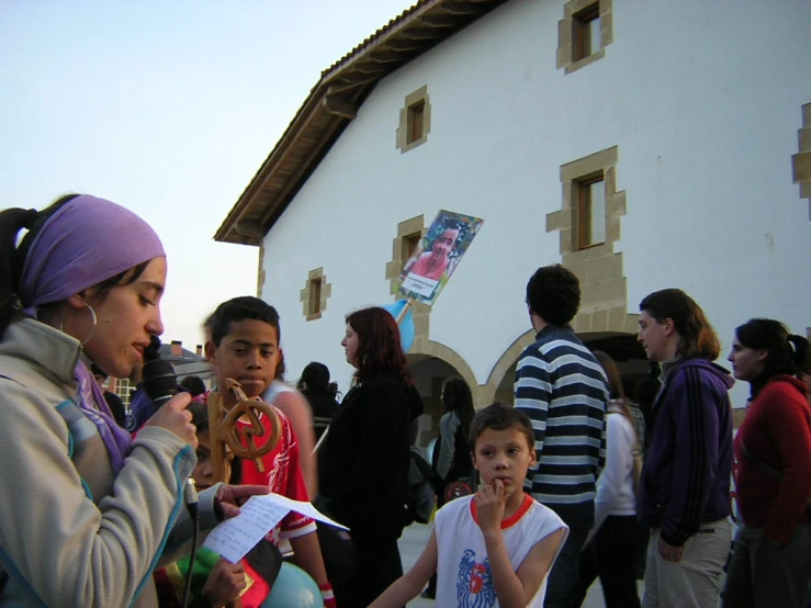 several people are standing together in front of a building