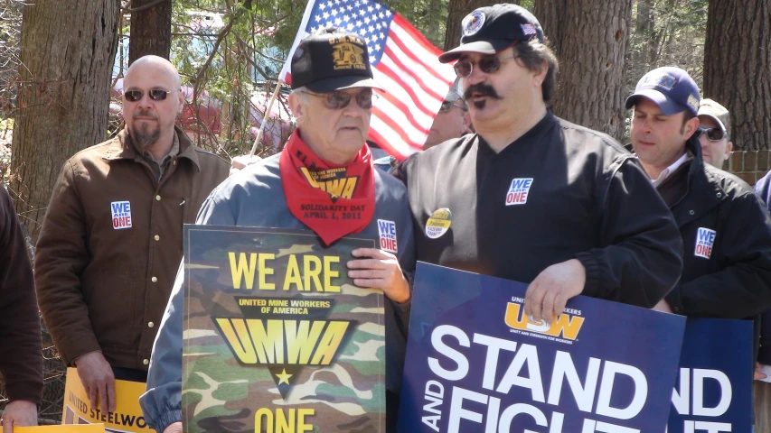 men in military attire holding up signs