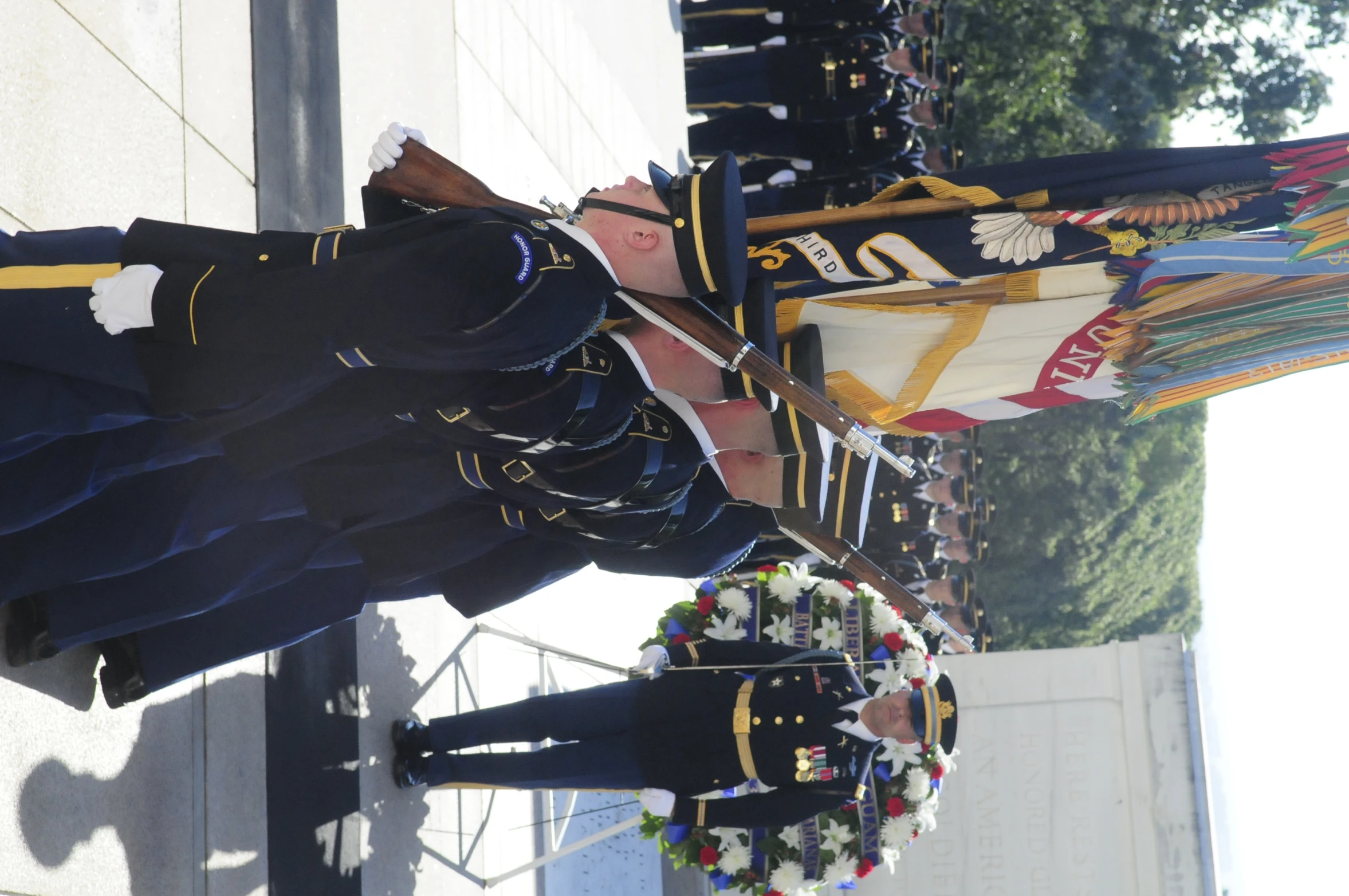 a few men in uniform are on the sidewalk