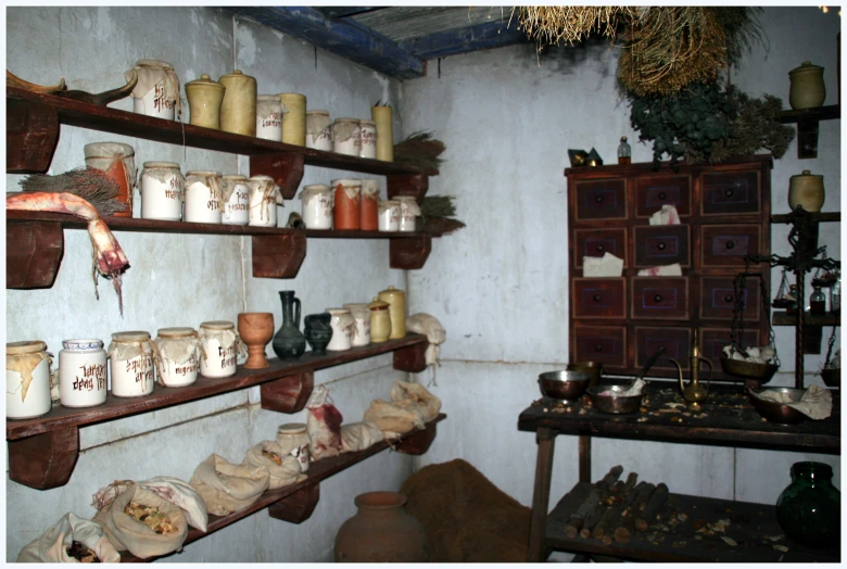 a display shelf full of various vases and jars