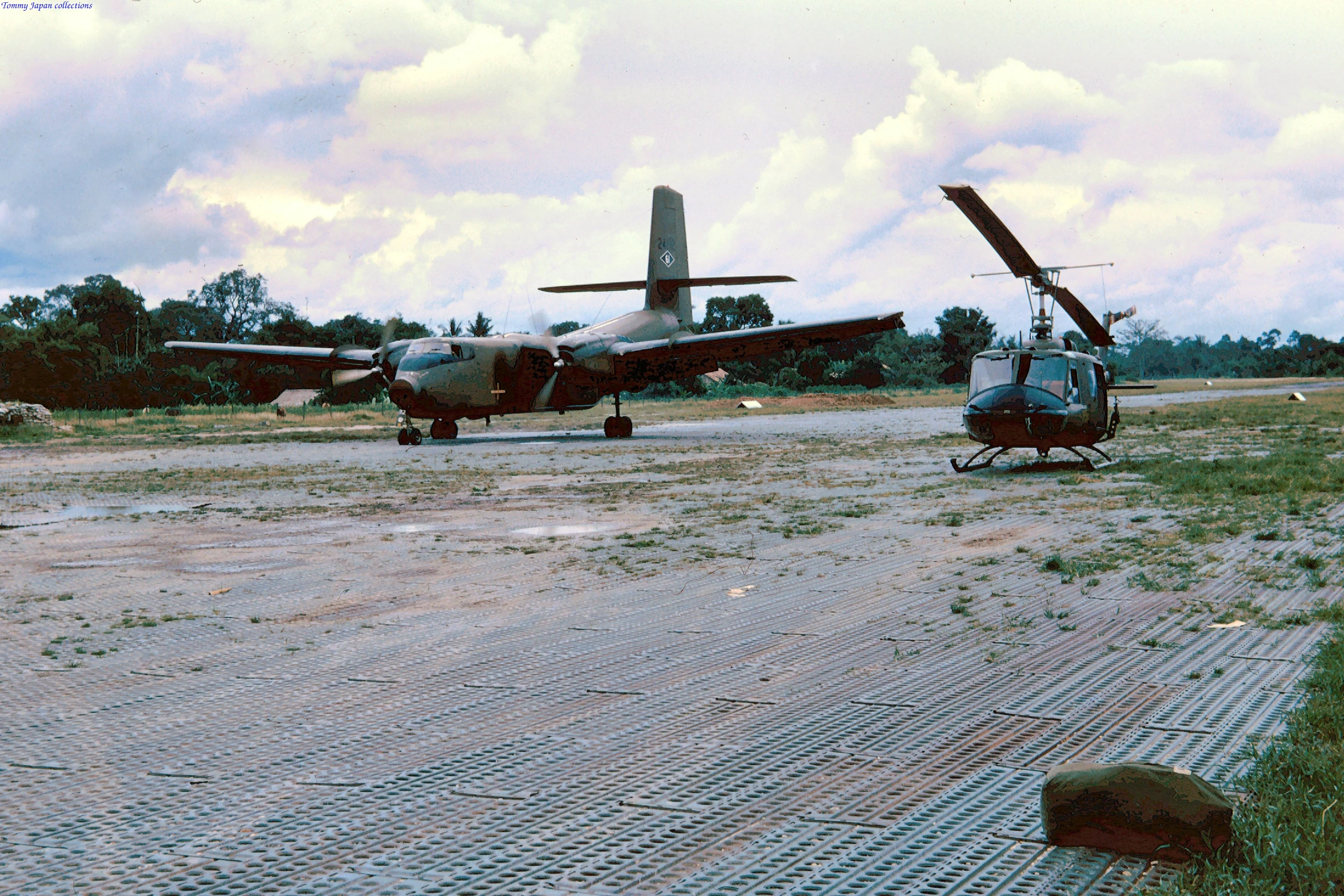 two old style planes on a dirt runway