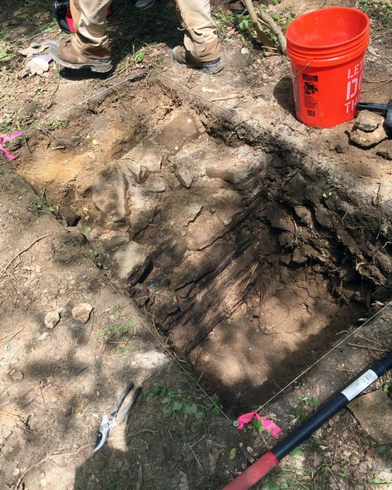 a person standing in front of a hole on the ground