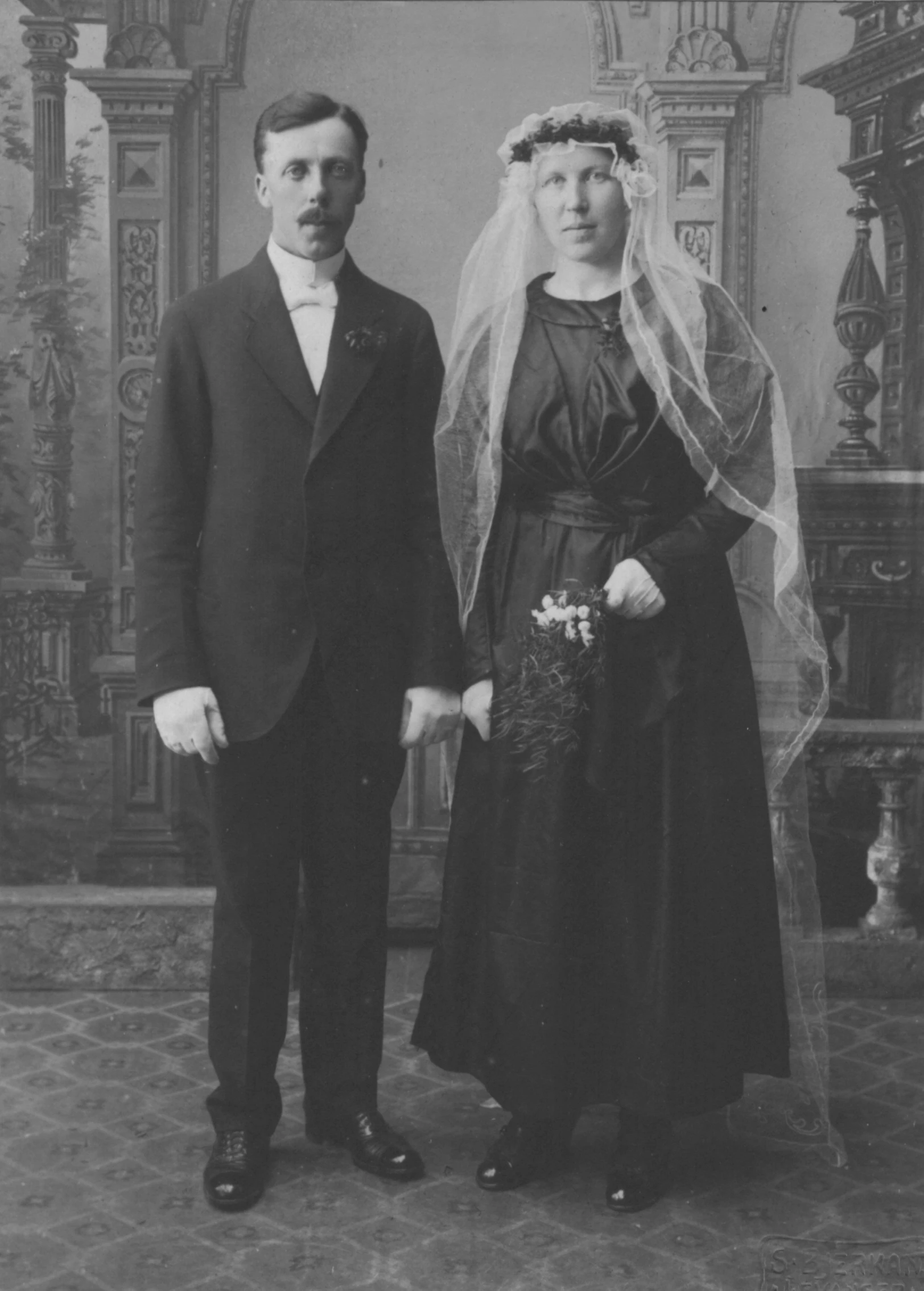 a woman and a man dressed in formal attire standing next to each other