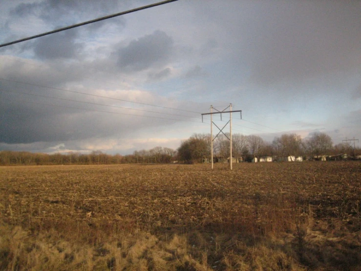 a view of an empty field under a cloudy sky