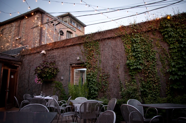 outdoor table and chairs in front of a building