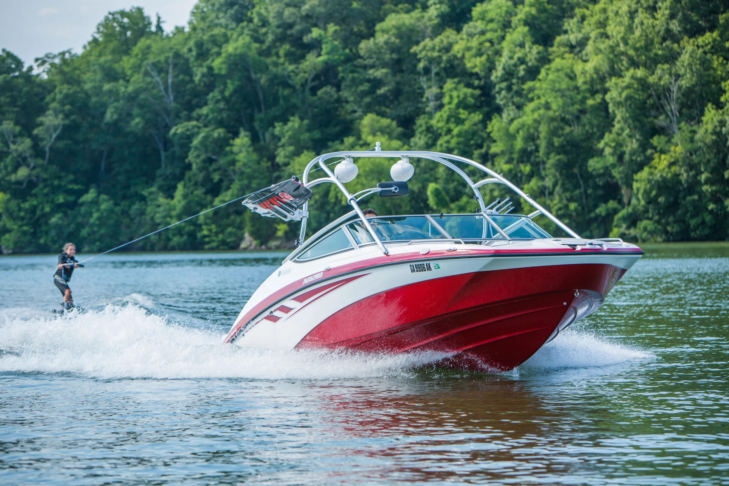 a red and white boat going down the water