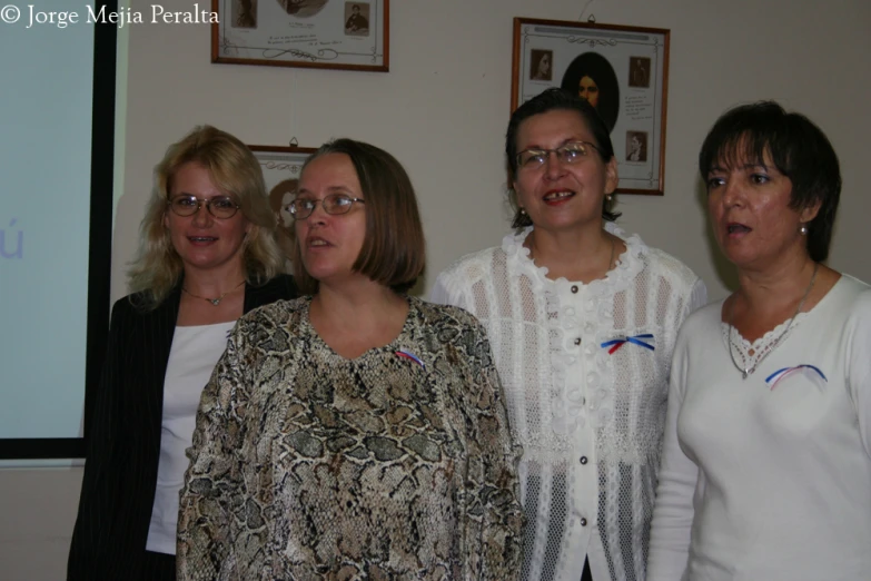 the three women are standing beside each other