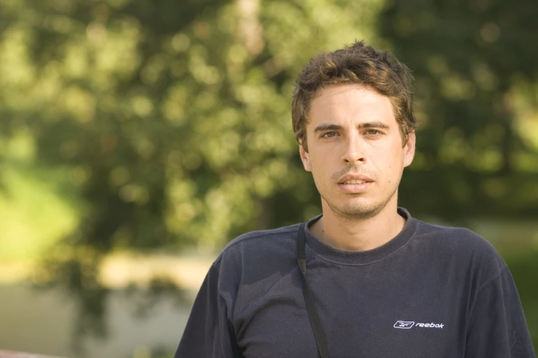 a close up of a person with trees in the background