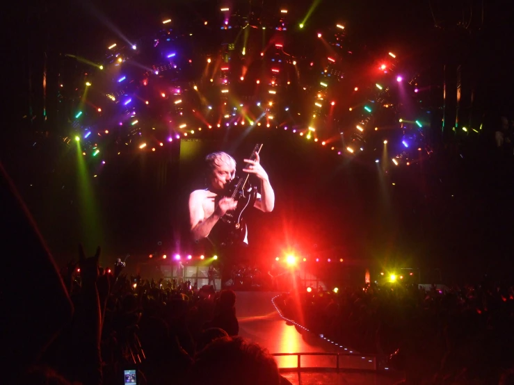 a man that is on a stage with his phone