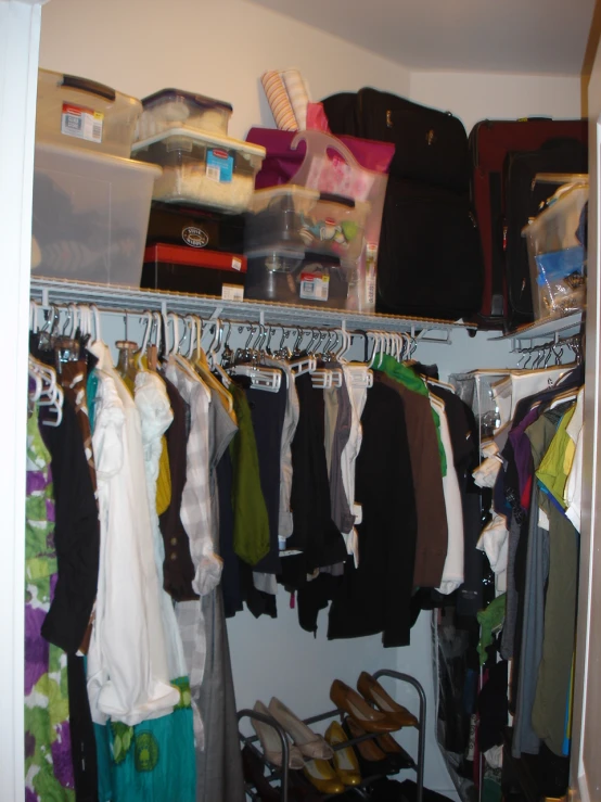 this is an organized closet with clothing and other stuff