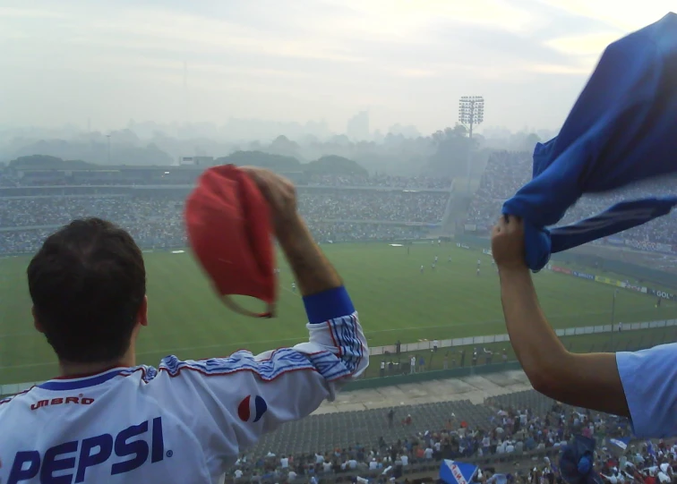 a soccer fans holds their flag over their head