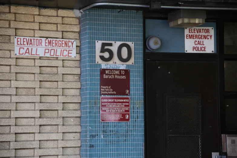 an emergency call booth with two signs on the wall