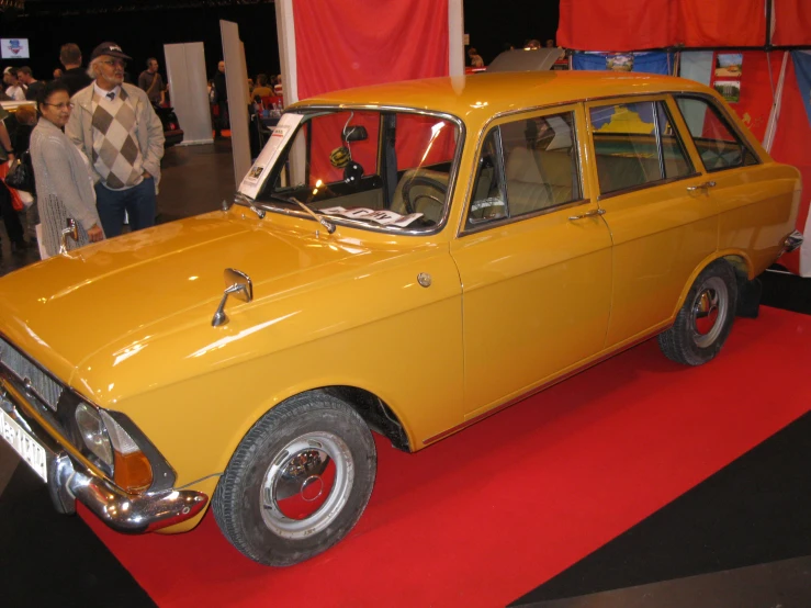 an old fashion car on display for people to see