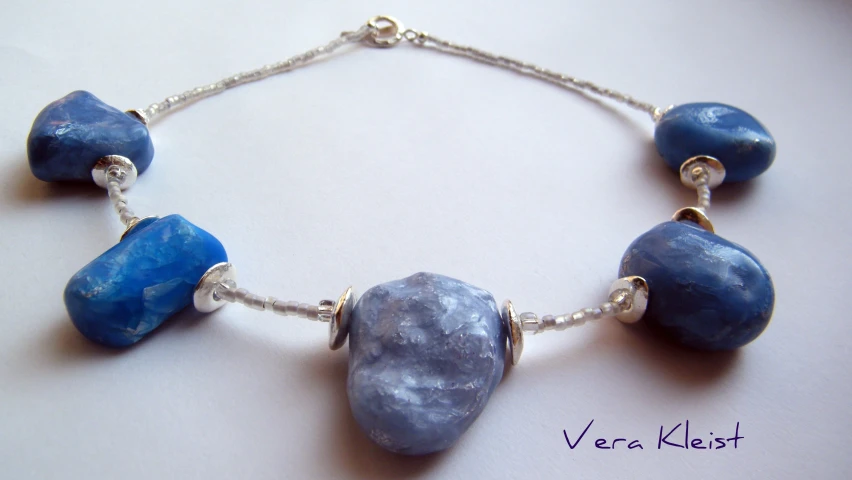 a necklace is made with blue glass beads