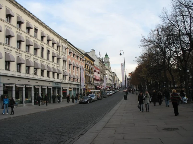 several people walking in the street of a city