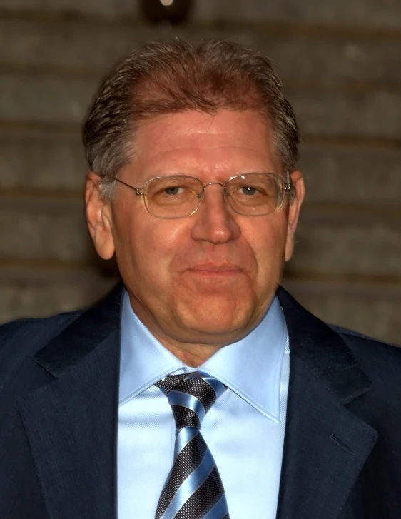 a man wearing a blue suit and tie