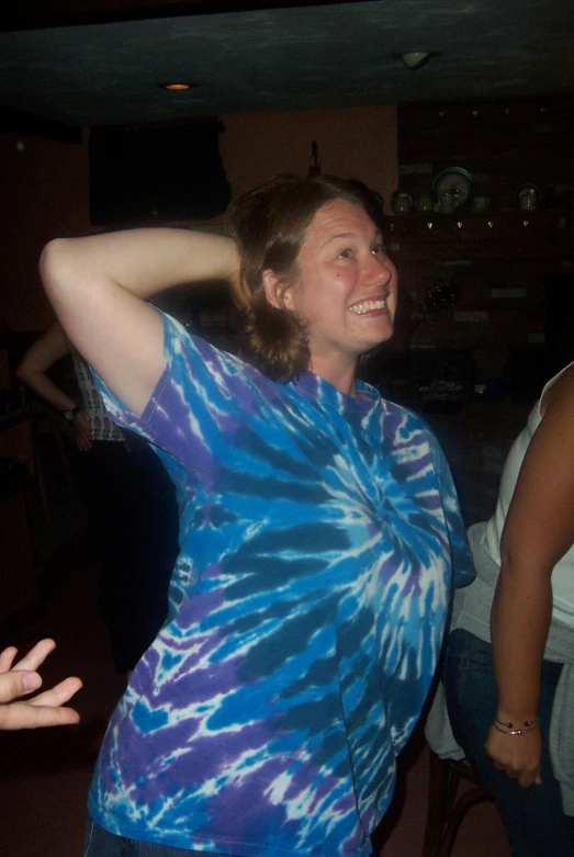 a woman is dancing at an indoor gathering