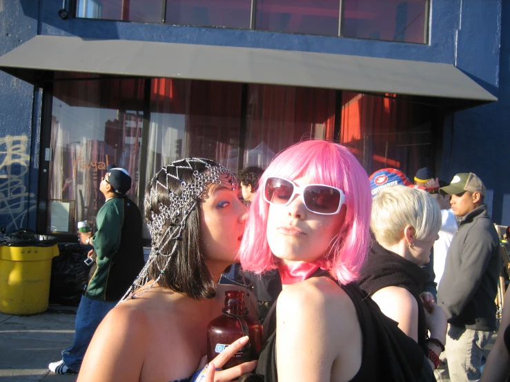 two women pose for the camera on the street