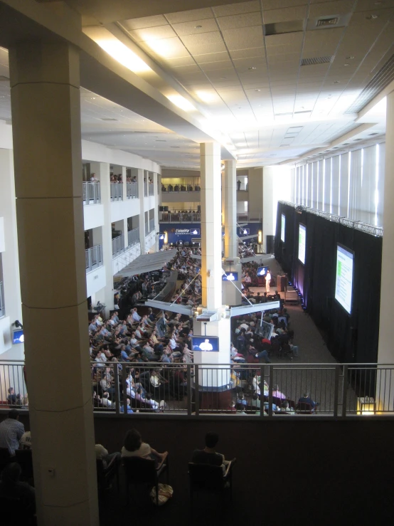 a large room full of people sitting down and watching television