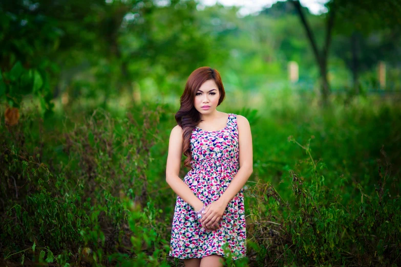 a woman standing on a field in a purple dress