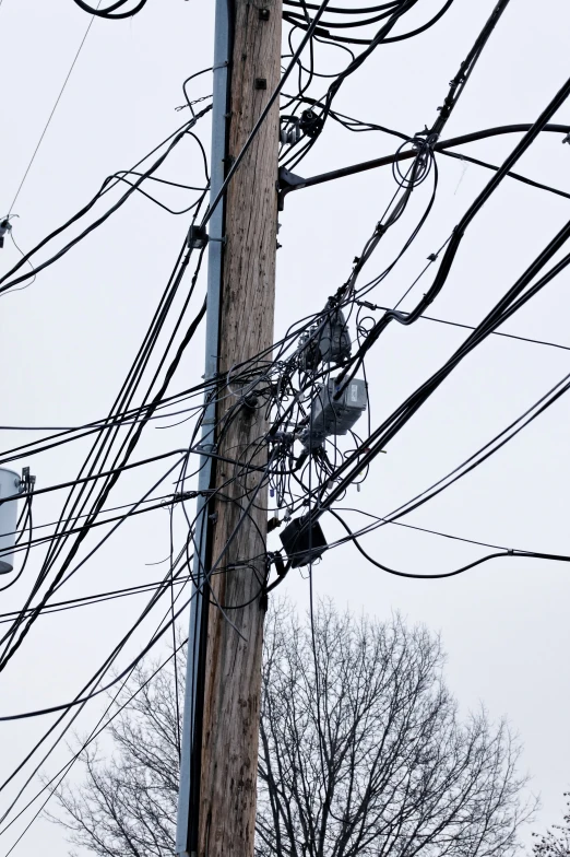 electric lines and wires hang in front of a blue sky