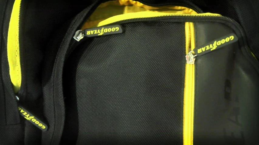 a yellow zipper is in a black suit case