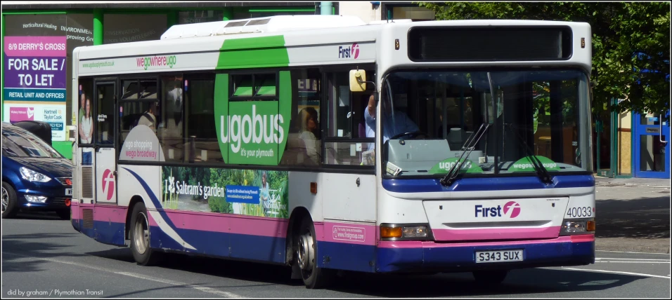 a colorful bus drives through the city streets