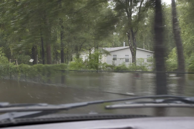 flooding with cars driving in the rain through trees