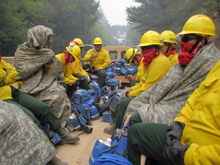 a group of people in yellow jackets sitting together