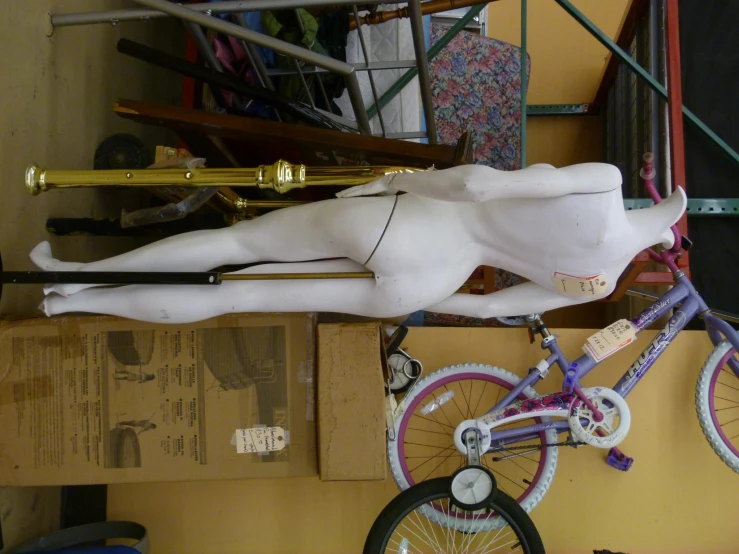 a mannequin and bicycle sitting on top of wooden boxes