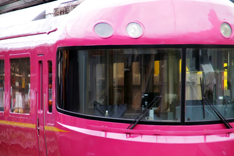 this is an image of a pink commuter train