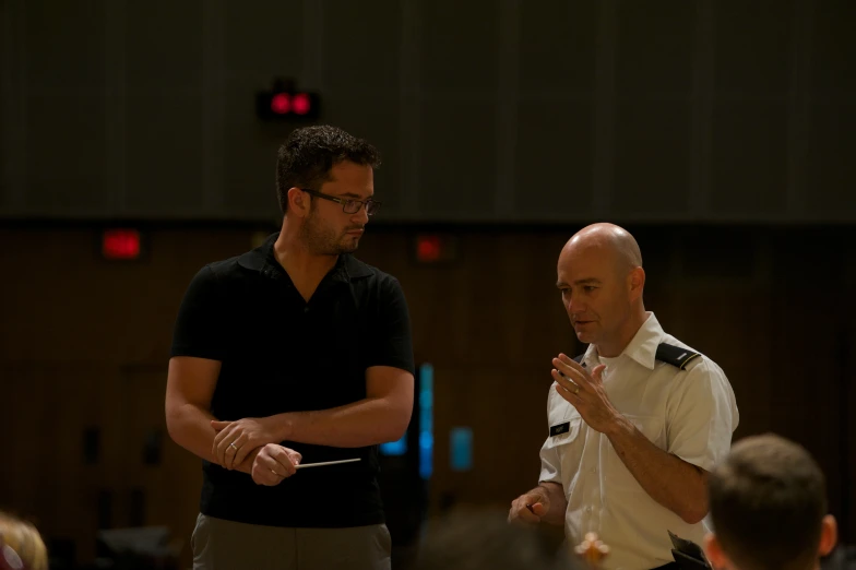 two men in a room talking together